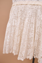 Load image into Gallery viewer, Vintage 1960s mermaid fit floral white lace dress is shown in close up. This midi length dress is by The Young Colony Shop.
