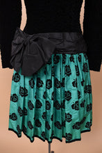 Load image into Gallery viewer, Vintage eighties green Escada drop waist dress is shown in close up. This dress has a pleated teal skirt with a rose floral print.
