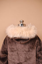 Load image into Gallery viewer, Vintage 60&#39;s brown faux fur fuzzy coat is shown from the back. This jacket has a white faux fur lining on the hood. 

