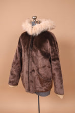 Load image into Gallery viewer, Vintage early 1960s faux fur brown hooded coat is shown from the side. 
