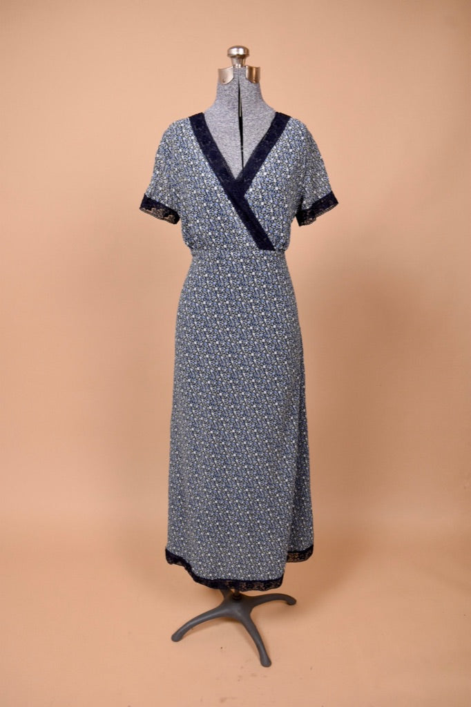 Vintage 1990's lacy blue floral Laura Ashley maxi dress is show from the front. This dress is made from a navy calico silk chiffon.