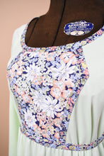 Load image into Gallery viewer, Mint green handmade prairie dress is shown in close up. This dress has a navy and pink floral print panel at the bust.
