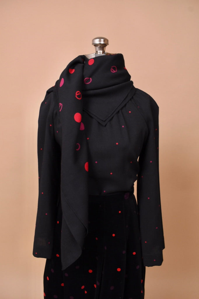 The top of the piece is seen up close with the scarf.