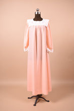 Load image into Gallery viewer, Vintage pink full length sleep dress shown from the front. This dress has a white lace bib collar.
