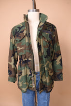 Load image into Gallery viewer, The jacket is visible from the front. The piece is unzippered.
